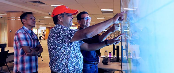 people interacting with touchscreen TV