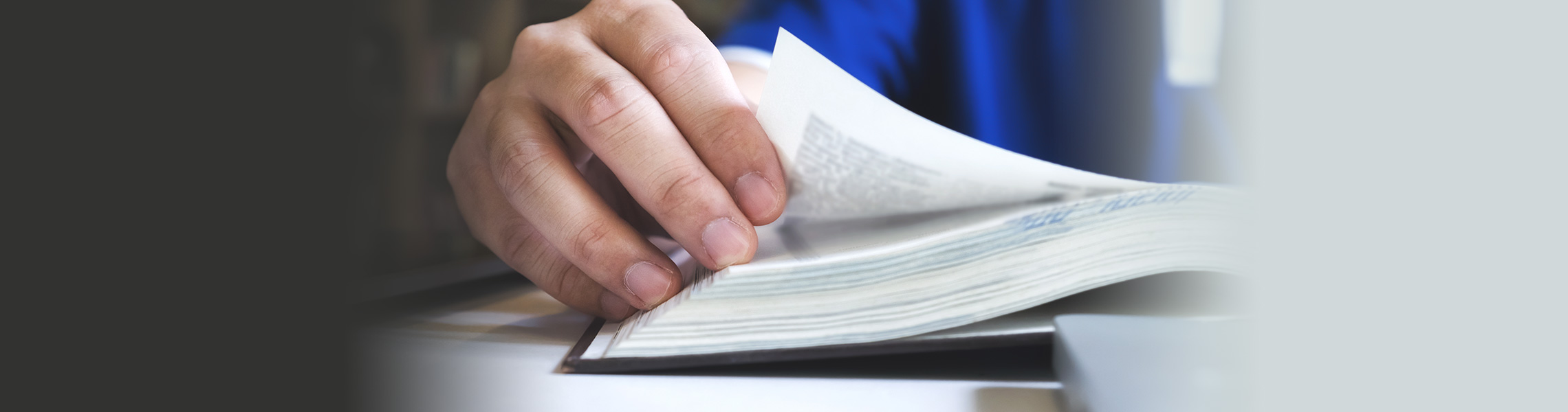 hand flipping through a book