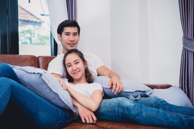 couple sitting on sofa couple sitting on sofa